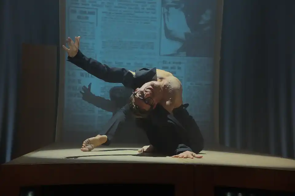 Performing dancer in a dynamic jump during a ballet.