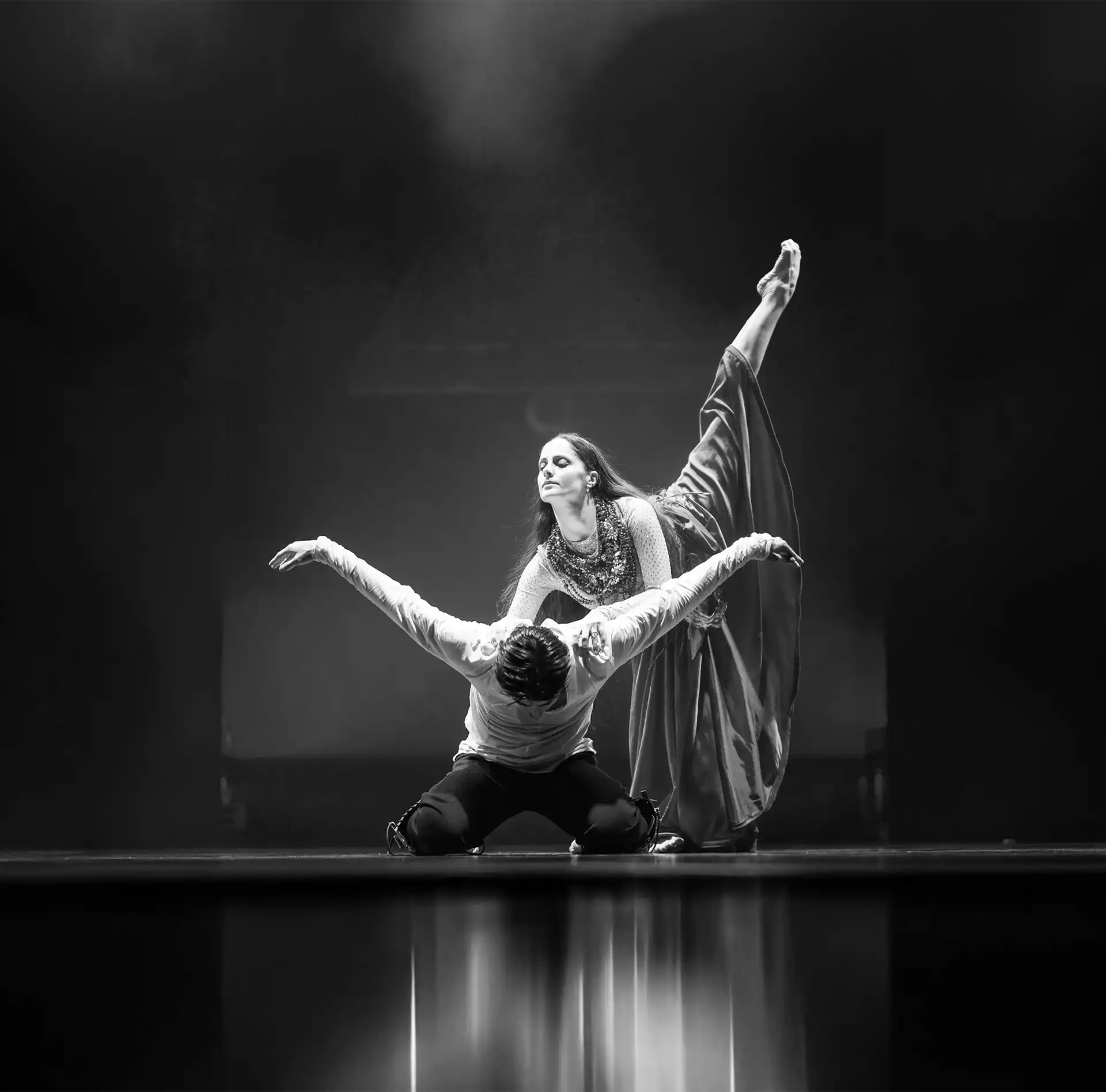 Performing dancer in a dynamic jump during a ballet.